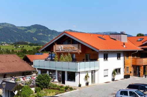 a building with an orange roof on a street at bichl 761 in Fischen