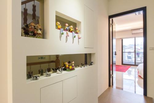 a kitchen with a bunch of toy figurines on the wall at Pure B&B in Hualien City