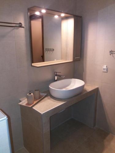 a bathroom with a sink and a mirror at Villa Anna in Ayios Nikolaos Sithonia