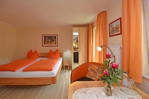a hotel room with a bed and a table at Hotel Haus Orchideental Jena in Jena
