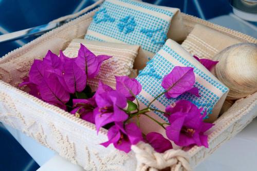 a basket with purple flowers in it on a table at La rosa dei venti in Villasimius