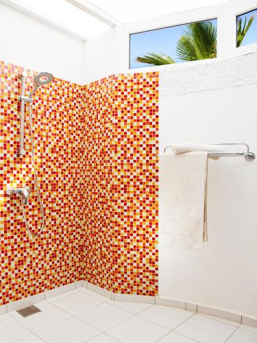 a bathroom with a shower and a red and white tiles at Casa Salinas in Morro del Jable