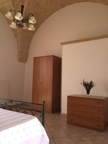 una camera con letto e armadio in legno di Casa Roma a Specchia