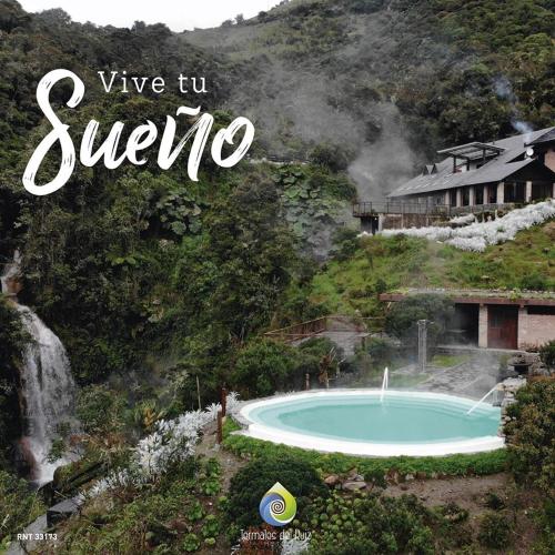 a sign that says give up syrica next to a swimming pool at Hotel Termales del Ruiz in Manizales