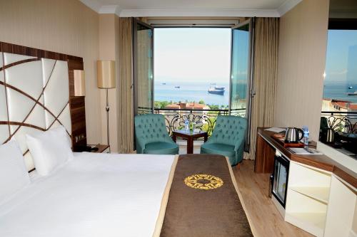 a hotel room with a bed and a view of the ocean at The Grand Mira Business Hotel in Istanbul