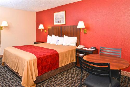 a hotel room with a bed and a table and a phone at Americas Best Value Inn-Near NRG Park/Medical Center in Houston