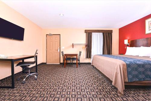 a hotel room with a bed and a desk at Americas Best Value Inn-Near NRG Park/Medical Center in Houston