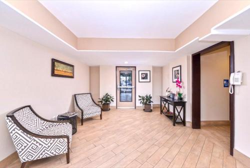a hallway with two chairs and a table in a building at Americas Best Value Inn-Near NRG Park/Medical Center in Houston