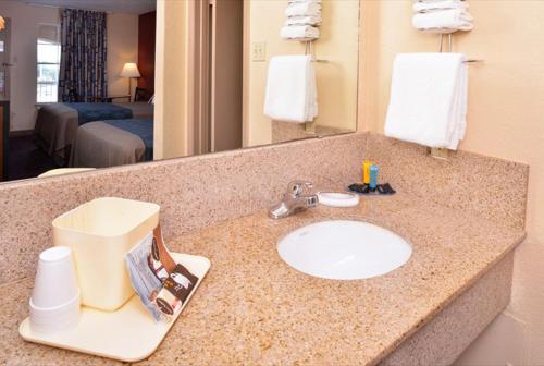 a bathroom counter with a sink in a hotel room at Americas Best Value Inn-Near NRG Park/Medical Center in Houston