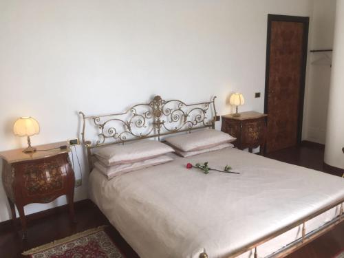 a bedroom with a bed with two tables and two lamps at Villa Puccini Bed & Breakfast in Lecco
