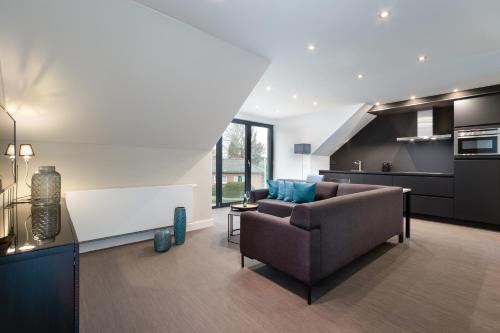 a living room with a couch and a kitchen at Intermezzo Emmerich in Emmerich