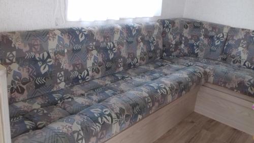 a couch sitting in a room with at Middenin in Grijpskerke