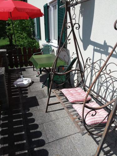 a couple of chairs and an umbrella on a patio at Haus Bergland in St. Wolfgang