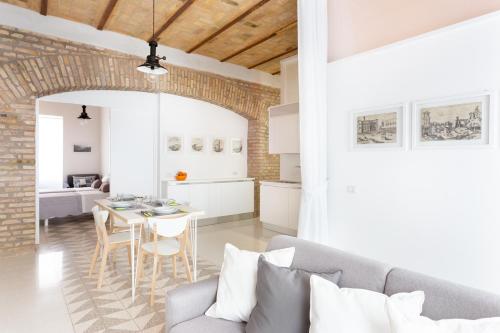 a living room with a couch and a table at Lilli Vatican White Domus in Rome