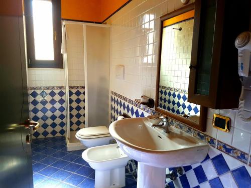 a bathroom with a sink and a toilet at Hotel Villa Elisabetta in Galatina