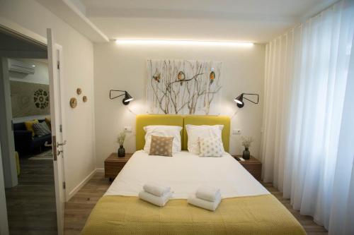 a bedroom with a large white bed with two pillows at Boavista Premium Family & Business by Porto City Hosts in Porto
