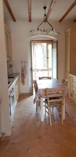 a kitchen with a table and chairs in a room at a casa di nonna Elza in La Spezia