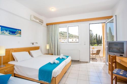 a hotel room with a bed and a tv at Mon Repos Hotel in Faliraki