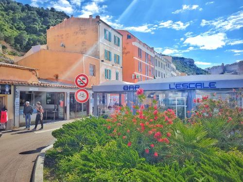 un groupe de bâtiments dans une rue fleurie dans l'établissement L'Escale, à Bonifacio