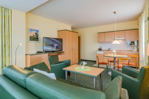 a living room with a couch and a table at Am Weststrand Aparthotel Kühlungsborn in Kühlungsborn