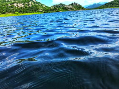 a large body of water with mountains in the background at Studio Apartment Cudo Nevidjeno in Karuč