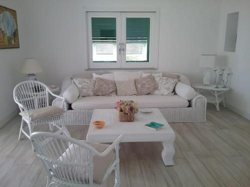 a living room with a couch and a table and chairs at Villa Biancaluna in Carloforte