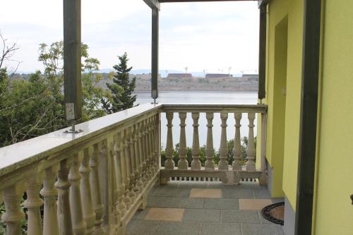 a balcony with a view of the water at Primavera in Omišalj