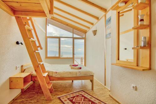 a small room with a bed and a window at Paradise Nest in Ohrid