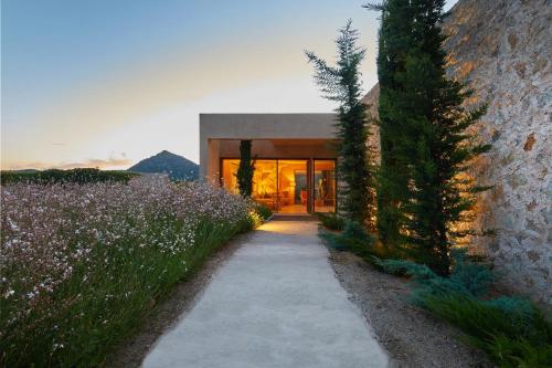 a house with a pathway in front of a building at Pleta de Mar, Grand Luxury Hotel by Nature - Adults Only in Canyamel