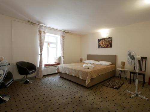 a bedroom with a bed and a fan and a window at Salve комнаты и апартаменты in Odesa