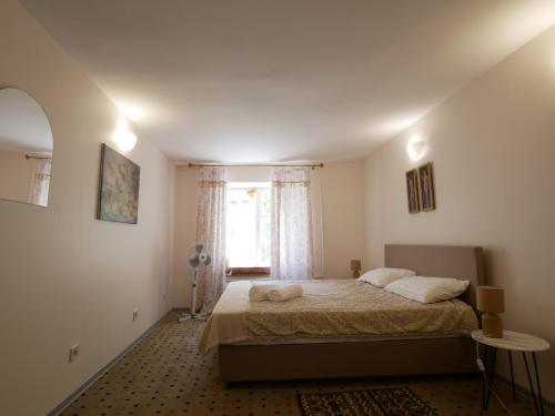 a bedroom with a bed and a window at Salve комнаты и апартаменты in Odesa