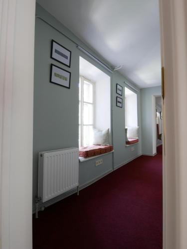 a room with two windows and purple carpet at Salve комнаты и апартаменты in Odesa