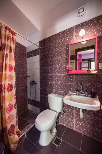a bathroom with a toilet and a sink at Manthiata Studios in Exanthia
