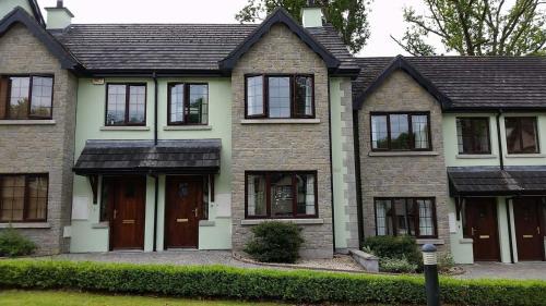 a house with brown doors and black windows at Lough Rynn Stylish Self-Catering in Mohill