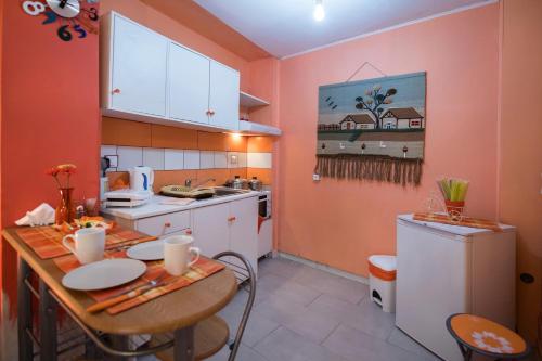 a small kitchen with a table and a refrigerator at Manthiata Studios in Exanthia