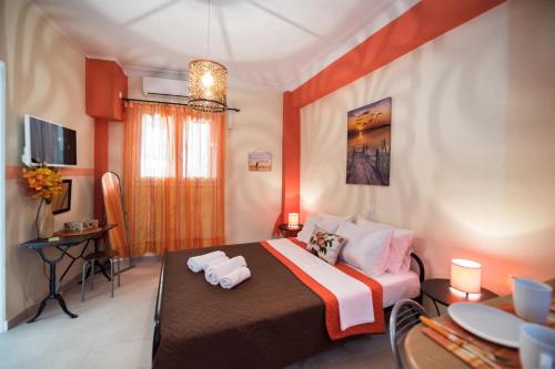 a bedroom with a bed with two towels on it at Manthiata Studios in Exanthia