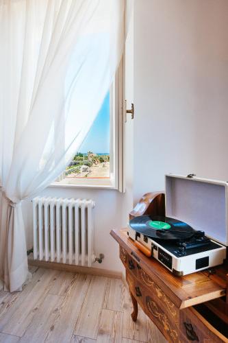 a room with a window and a table with a laptop at Villa Francesca Luxury - Adriatic Nature & Heritage House in Grottammare