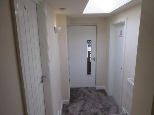a hallway with a door leading into a room at Anchor House 2 East Street Alford Lincolnshire LN13 9EQ in Alford