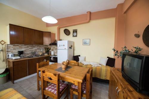 a kitchen and living room with a table and a couch at Manthiata Studios in Exanthia