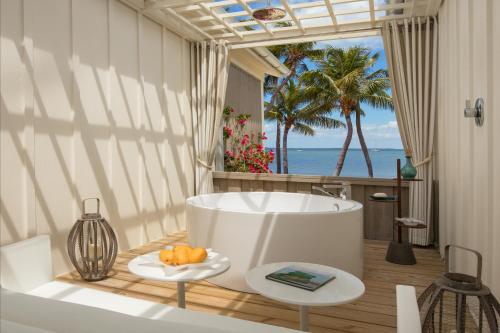 a bathroom with a tub and a view of the ocean at Bungalows Key Largo - All Inclusive in Key Largo