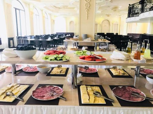 a buffet with plates of food on a table at Borjomi Palace Health & Spa Center in Borjomi