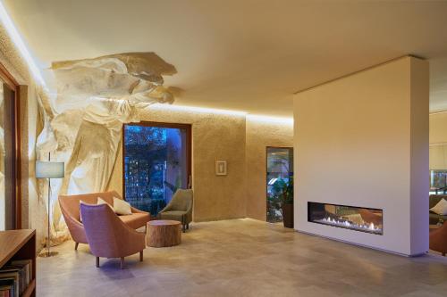 a living room with a couch and a fireplace at Pleta de Mar, Grand Luxury Hotel by Nature - Adults Only in Canyamel