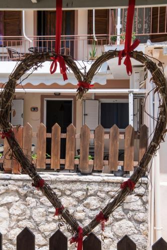 a heart shaped wreath on the side of a house at Manthiata Studios in Exanthia