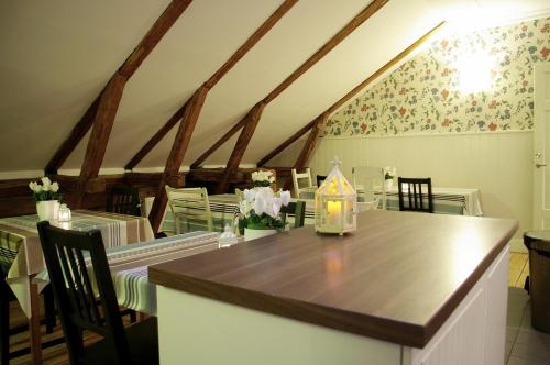 a dining room with a table and chairs and a room with a ceiling at Vandrarhem Uppsala Kungsängstorg in Uppsala