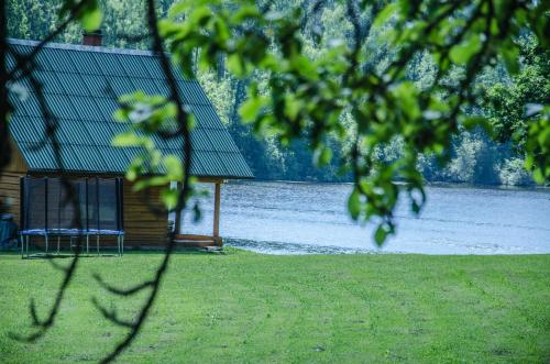 a cabin on the shore of a body of water at "Čiekuri" in Aglona