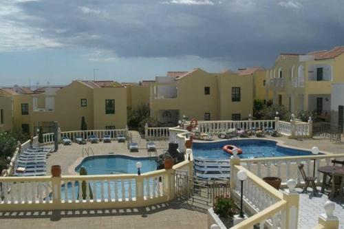 a view of a swimming pool at a resort at Caleta Paraiso - Lovely Coastal Apartment in Costa de Antigua