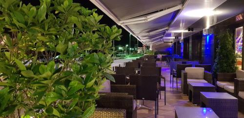 a row of tables and chairs in a restaurant at night at Hotel Pimar & Spa in Blanes