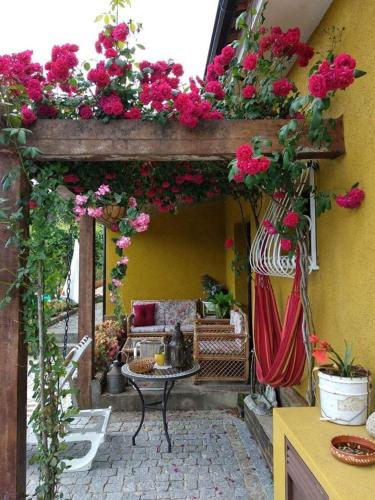 a patio with flowers and a table and a couch at King's House Douro Valley in Sedielos