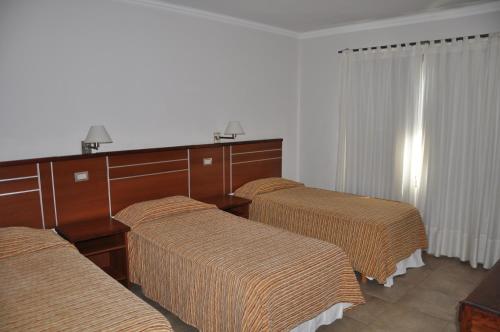 A bed or beds in a room at Hotel Savoia Mendoza