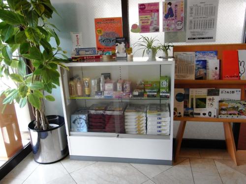 a white refrigerator with food inside of it at Kotohira Riverside Hotel in Kotohira
